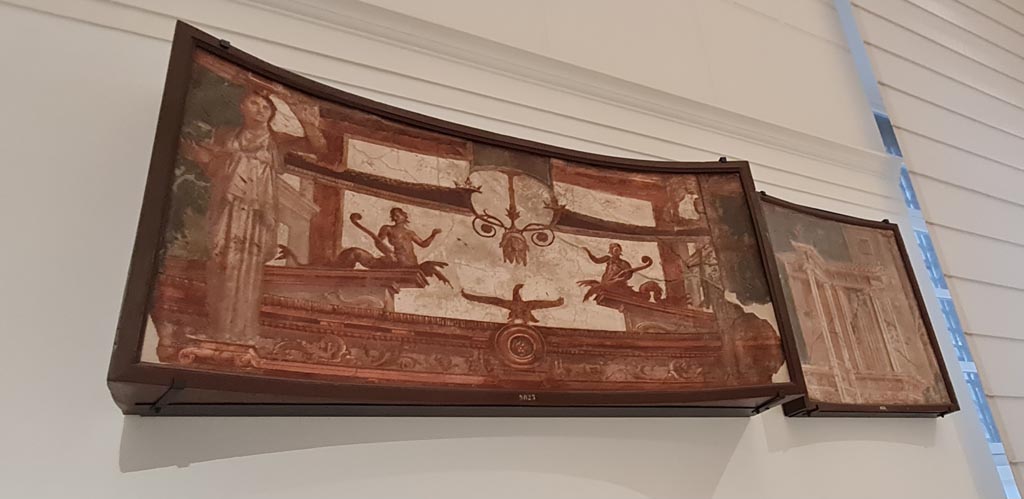 Herculaneum Augusteum. April 2023.
No.1 on above descriptive card – Fastigium (upper panel) of a shrine with Caryatids, inv. 9825.
and
No.2 on above descriptive card – Building with window and colonnade shown in perspective, inv. 8534.
On display in “Campania Romana” gallery in Naples Archaeological Museum. Photo courtesy of Giuseppe Ciaramella.