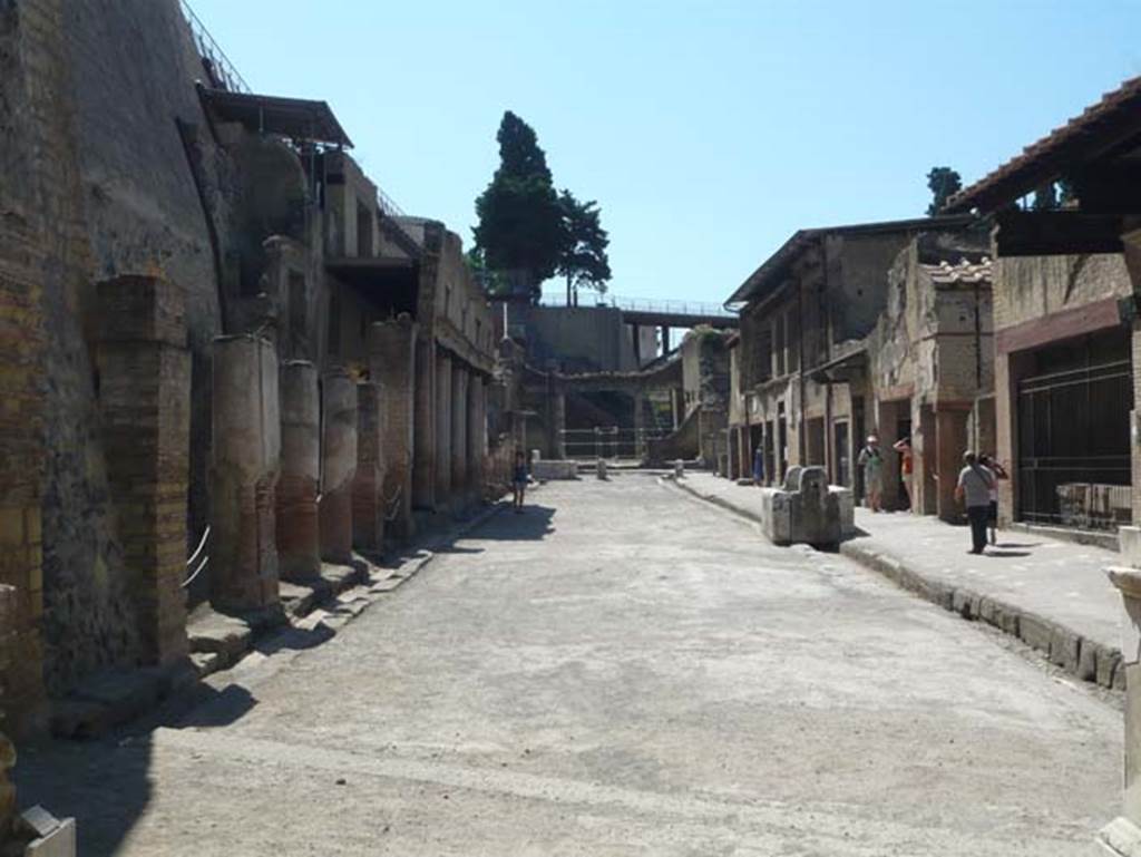 Herculaneum. August 2013. Looking east along Decumanus Maximus, from four-sided arch. The entrance doorway shown in the photo above, is on the left behind the ropes. Photo courtesy of Buzz Ferebee.