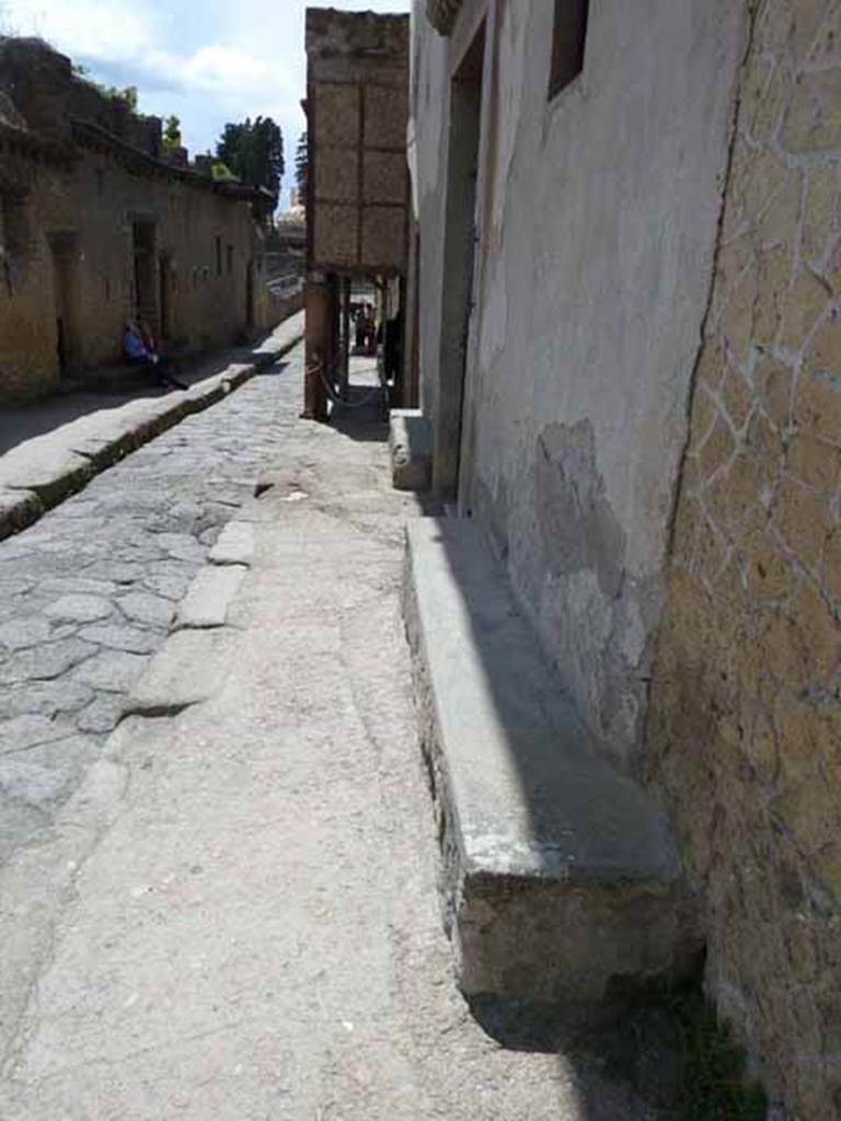 III.11 Herculaneum. May 2010. Looking south along two masonry benches outside front facade.
