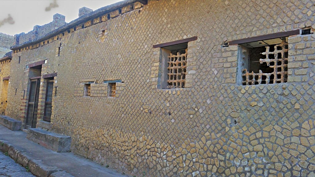 IV.4 and IV.3 Herculaneum, on left, photo taken between October 2014 and November 2019.
Looking north along front façade on east side of Cardo IV. 
Above the doorways are the remains of the holes for the support beams of a long overhanging gallery. Photo courtesy of Giuseppe Ciaramella.

