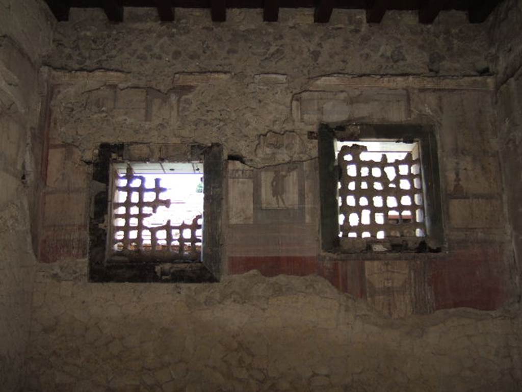 IV.4 Herculaneum. May 2006.  Room 19, two windows in west wall, with iron gratings and part of the wooden frame of the window.
