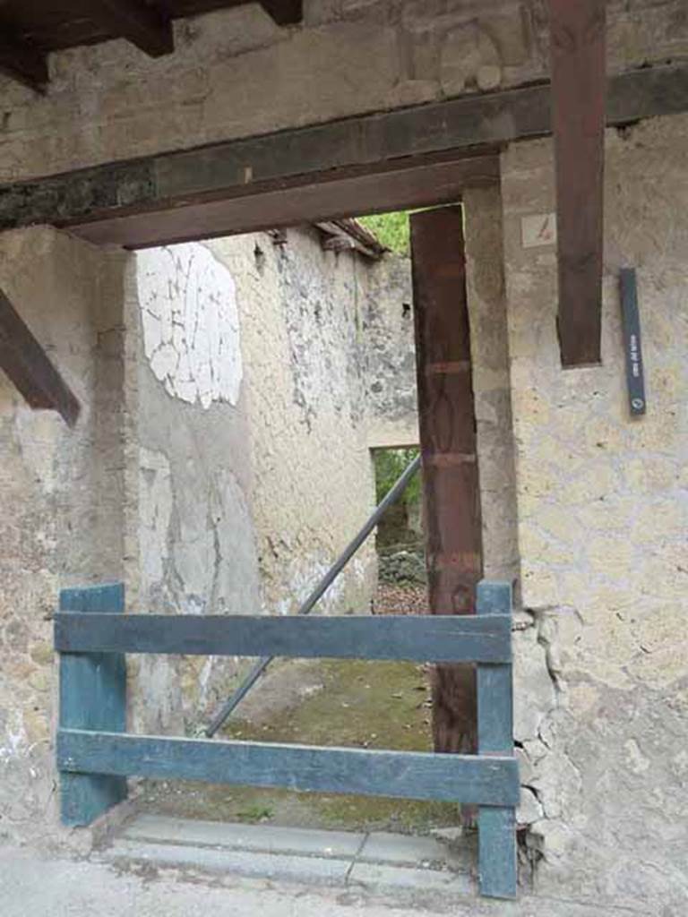 V.4. Herculaneum. May 2010. Entrance doorway. 
On the top right-hand side of the doorway is a phallus sculpted above the lintel for protection against the evil eye. 