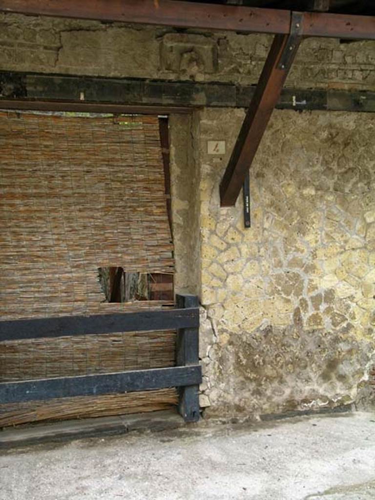 V.4, Herculaneum, May 2005. Exterior façade on south side of doorway, on east side of Cardo IV. 
Photo courtesy of Nicolas Monteix.

