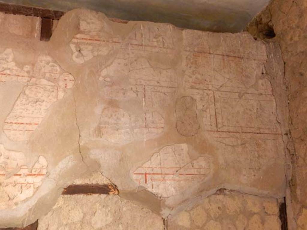 V.8 Herculaneum. May 2018. Room 1, remaining painted decoration at west end of south wall. Photo courtesy of Buzz Ferebee. 

