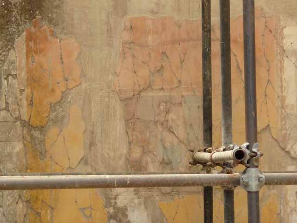 V.11 Herculaneum. May 2010. Looking towards south wall of tablinum. 
The central wall painting on the south wall was Apollo Citaredo or Apollo, the Lyre-Player.
This painting showed Apollo playing a lyre and crowned with laurel; a nymph, and on one side, a cupid supports the gods heavy quiver.


