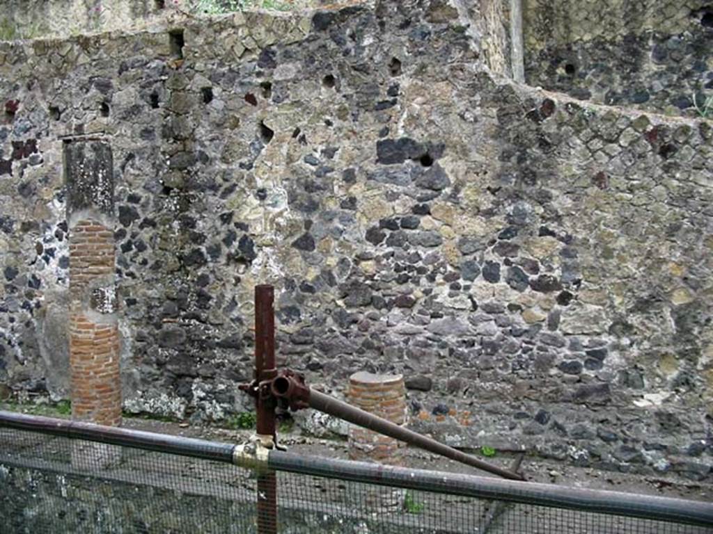 V.11, Herculaneum. May 2003. West exterior wall which would have been under a portico on Cardo IV. 
Photo courtesy of Nicolas Monteix.
Behind the wall, on the left, would be the area of the first and second rooms on the west side of the atrium.
Behind the wall, on the right, would be the area of the large rear room on west side of tablinum.
