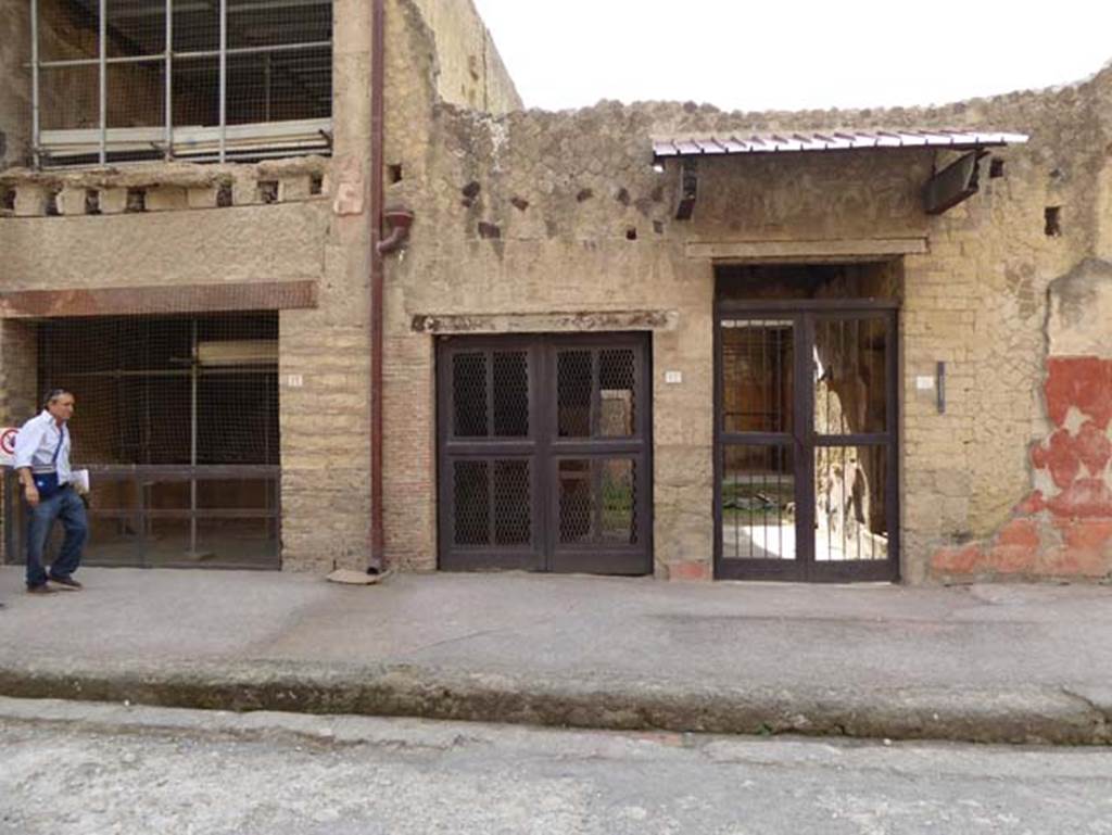 V.11, Herculaneum, on right. October 2014. Looking south on decumanus Maximus to entrances at V.13, left, and V.12, centre.  Photo courtesy of Michael Binns.
