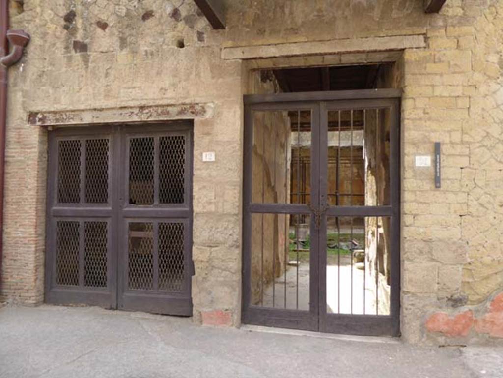 V 12 doorway on left, and V.11, House of Apollo the Lyre-Player, on right. October 2014. Looking south to entrance doorways.  Photo courtesy of Michael Binns.
