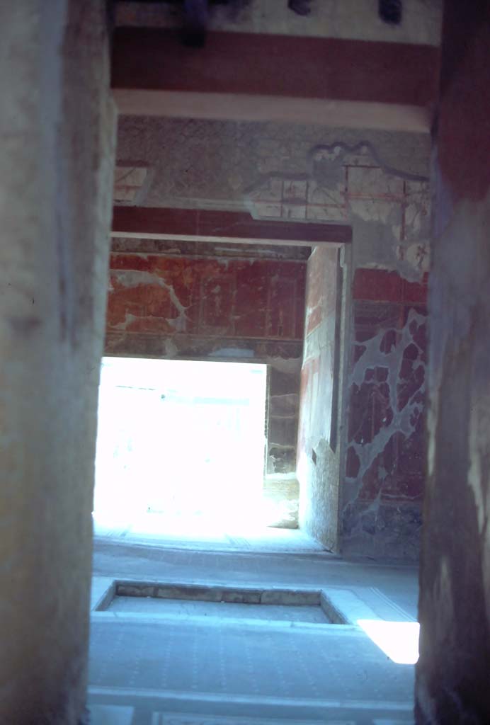 V.15 Herculaneum, 7th August 1976. Looking south from entrance corridor, across atrium to tablinum.
Photo courtesy of Rick Bauer, from Dr George Fays slides collection.

