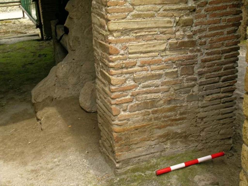 V.19 Herculaneum. May 2005. 
Looking north from rear room near doorway to V.20, towards latrine and hearth against east wall of shop-room. Photo courtesy of Nicolas Monteix.
