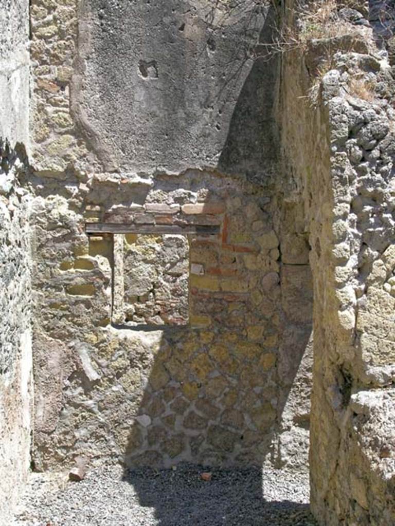 V.27 Herculaneum. May 2005.
Looking towards north wall of rear corridor/room with small window into second room, on north side of corridor. 
Photo courtesy of Nicolas Monteix.
