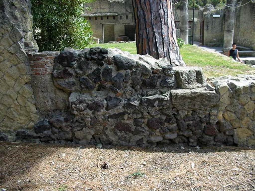 V.34, Herculaneum. May 2003. Remains of east wall of shop. Looking east towards garden of V.33 on corner of Cardo V, and Decumanus Inferiore. Photo courtesy of Nicolas Monteix.

