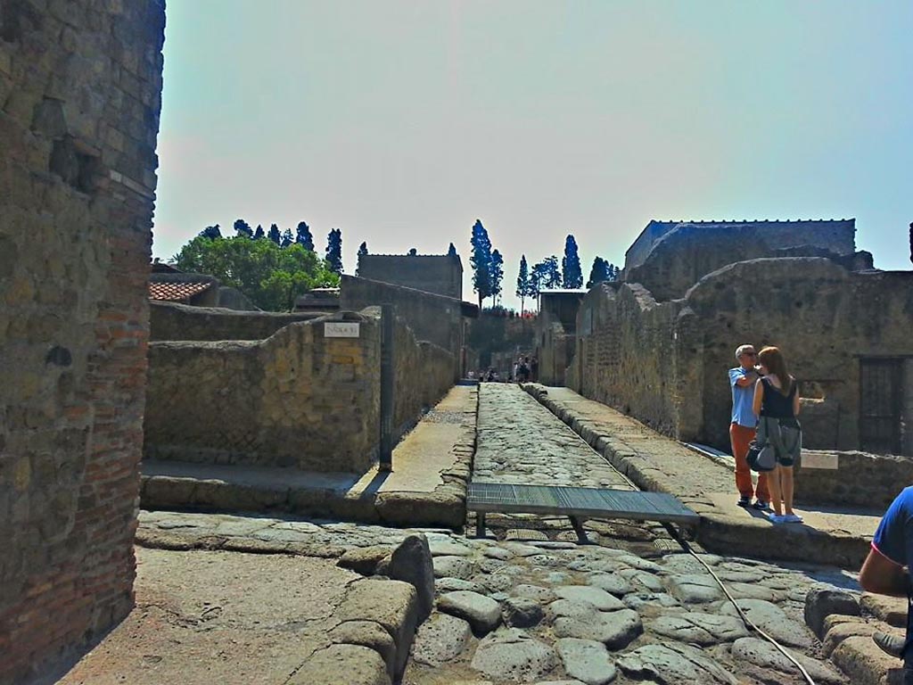 Decumanus Inferiore, looking east across junction with Cardo III Superiore on left, and Cardo III Inferiore on right.
Ins. VI corner, on left ahead. Corner of Ins. III on right ahead. 
Photo taken between October 2014 and November 2019.  Photo courtesy of Giuseppe Ciaramella.
