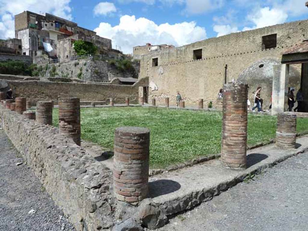 VI.1/7. May 2010. Looking north-west across the palaestra of the mens baths, from the south-east portico, and near entrances at VI.5 and VI.7. 