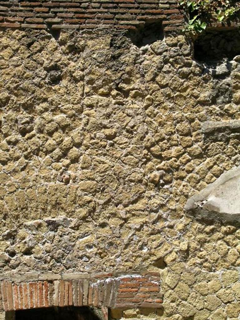 VI.9, Herculaneum. May 2005. Detail of upper facade above entrance doorway. 
Photo courtesy of Nicolas Monteix.

