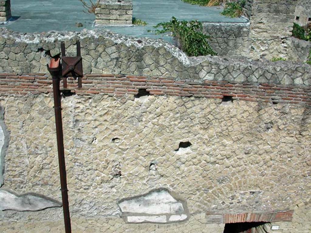 VI.9, Herculaneum. September 2003. 
Looking west to detail of upper facade, and roof area originally attics and terraces, above entrance doorway.Photo courtesy of Nicolas Monteix.


