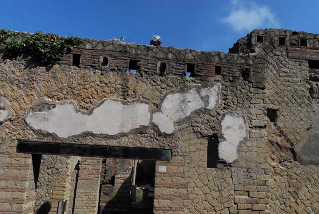 VI.10, Herculaneum, June 2008. Exterior upper facade on west side of Cardo IV, near doorway.
Photo courtesy of Nicolas Monteix.
