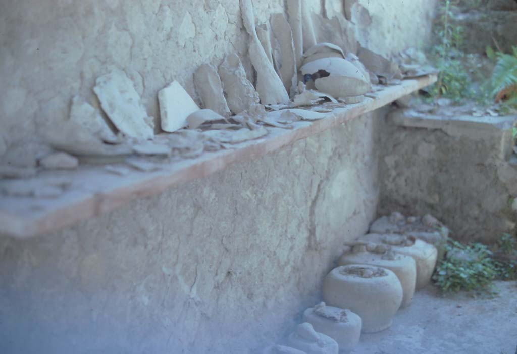 VI.12 Herculaneum. 7th August 1976. Looking towards east wall and south-east corner of workshop.
Photo courtesy of Rick Bauer, from Dr George Fay’s slides collection.
