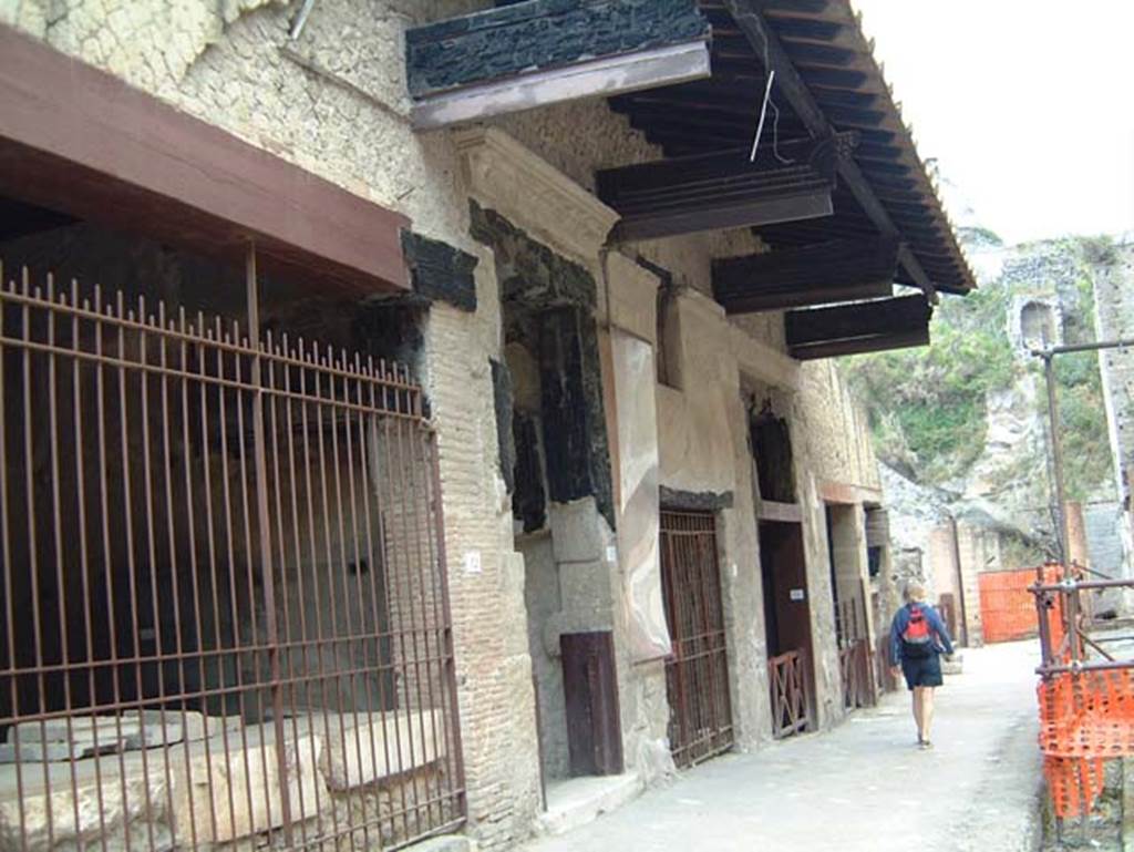 VI.12 Herculaneum, on left. May 2001. Looking west along north side of insula, on Decumanus Maximus.  Photo courtesy of Current Archaeology.
