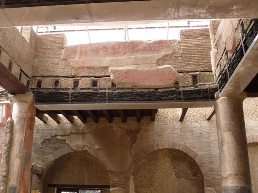 Ins.VI.21, Herculaneum. May 2009. Carbonized beams from upper floor. Looking west towards area with reconstructed modern floor beams of upper floor.
Photo courtesy of Buzz Ferebee.
