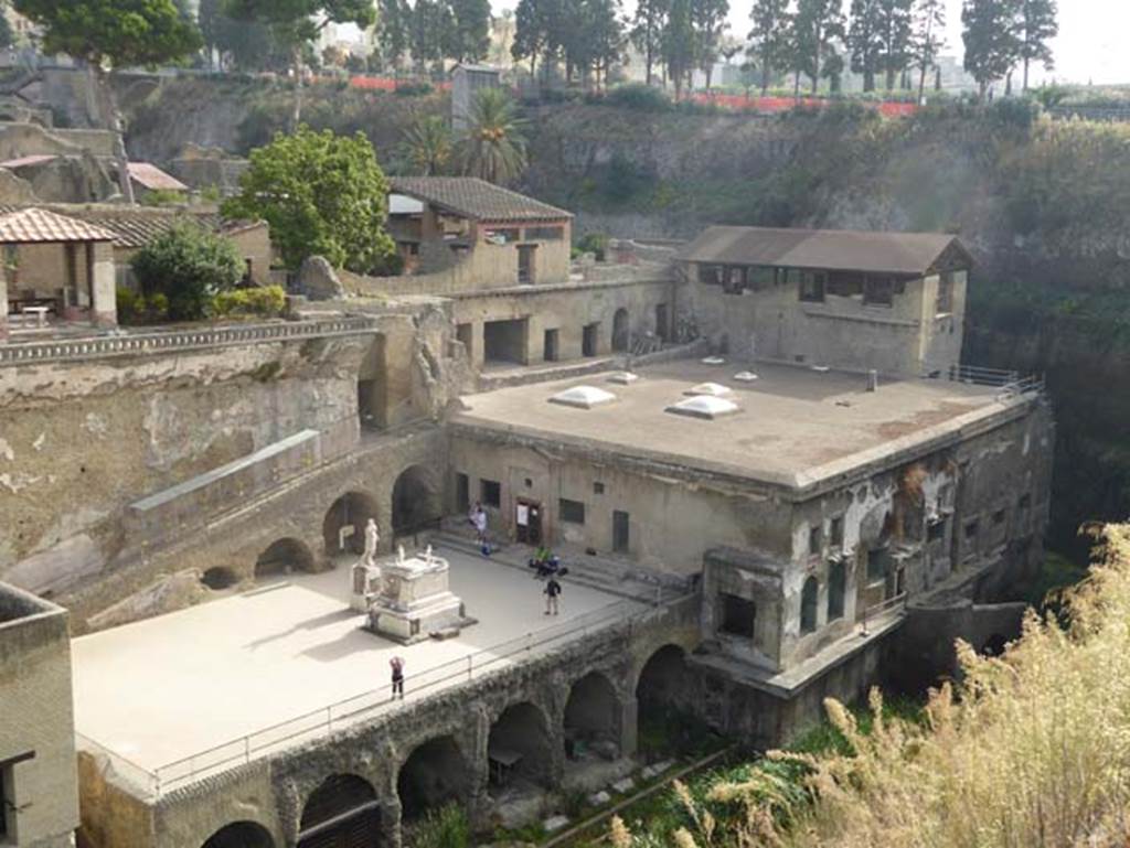 Ins. Orientalis I, 1a, Herculaneum, October 2014. Looking north-east from access road.
At the top of the photo on the left is the House of the Stags or Deer.
In the centre of the upper photo are the upper rooms forming the House of the Gem, beneath this is a terrace with rooms opening onto it. 
These now form the House of M. Pilius Primigenius Granianus.
In the upper right are the tower rooms of the House of the Telephus Relief. 
Beneath these are the Suburban Baths. Photo courtesy of Michael Binns.
