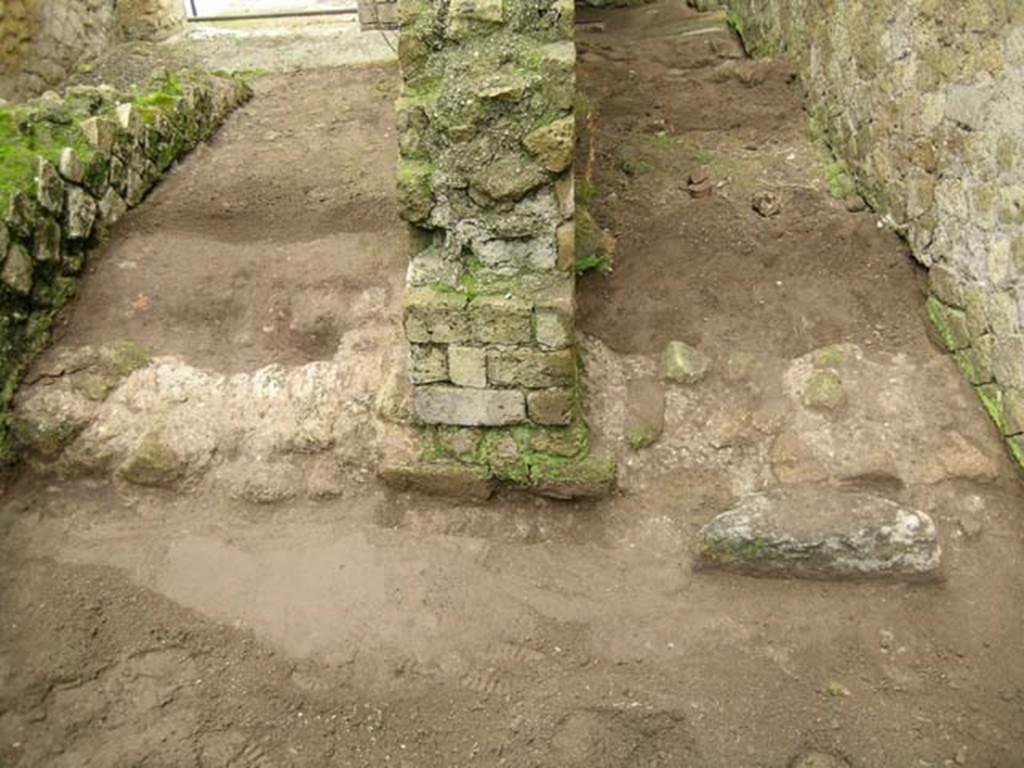 Ins. Orientalis II.7, Herculaneum. December 2004. 
Looking west along area that would have been under the stairs to the upper floor, on left side of photo. 
Looking west along the latrine/room on the south side of the mill-room of Ins. Or. II.8, on right side of photo.
Photo courtesy of Nicolas Monteix.
