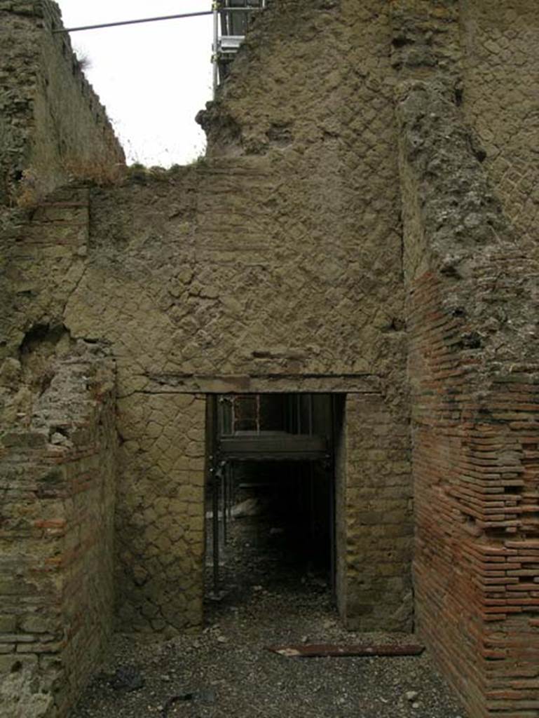 Ins. Or. II.7, Herculaneum. June 2006.  
Looking west towards doorway in west wall of a room, reached by Ins.Or.II.7, but which may be part of the rooms of the Palaestra at Ins.Or.II.4 (room C).
Photo courtesy of Nicolas Monteix.

