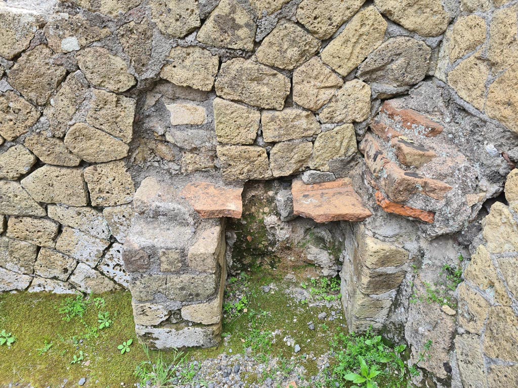 IV.10, Herculaneum. May 2024.
Looking east towards altar in rear room, with possible arched niche above. Photo courtesy of Klaus Heese.