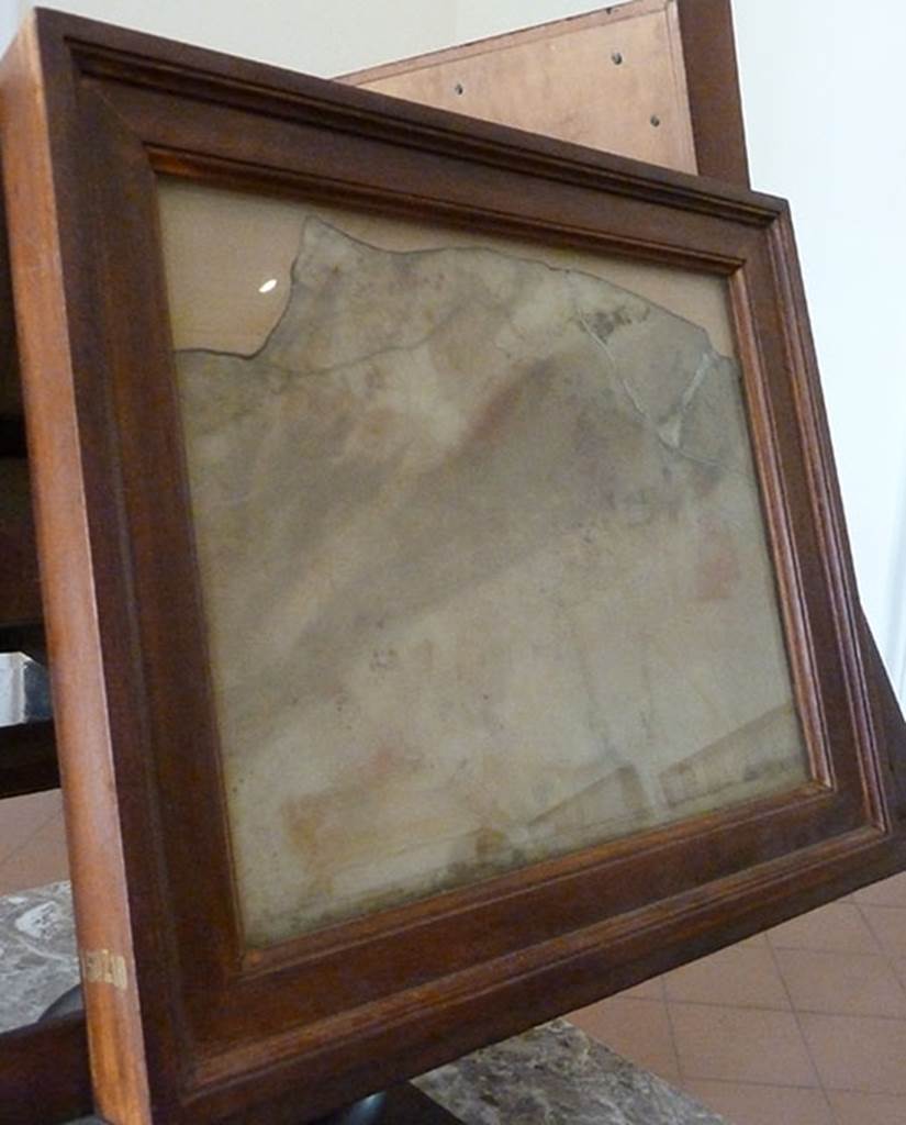 V 7, Herculaneum. Lararium in atrium. Scene painted on marble.
According to Grasso, the lararium near to the cella ostiaria of the atrium had a fine marble decoration of which were recovered only two monochromes on marble.
In this slab, however very damaged by the heat, one can see on the left a female figure…….. Near to which was a male figure………
The pose of the female figure makes one think of Phaedra, …….. or else Dido beside Ascanius, or Helen at the side of one of the Dioscuri.
Now in Naples Archaeological Museum. Inventory number 150210.
See Sampaolo V. and Bragantini I., Eds, 2009. La Pittura Pompeiana. Electa: Verona, p. 119, 14b.
On the second panel, also painted on marble, were some female figures dancing near an altar, behind which was a pillar surmounted by a bearded male figure in the act of shaking a rod.
Next to the pillar was Eros (next to which was written the name) with the bow.
To the left the panel was very ruined and only the feet of two figures could be made out.
At the bottom left the picture was signed by the artist, “Alexandros Athenaios egrapsen”, Alexander of Athens composed this.
Now in Naples Archaeological Museum. Inventory number 150211.
See Sampaolo V. and Bragantini I., Eds, 2009. La Pittura Pompeiana. Electa: Verona, p. 119, 14a.