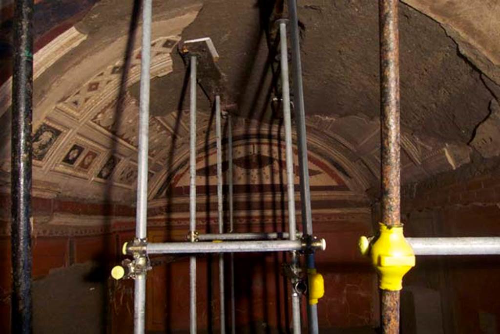 Villa dei Papiri, Herculaneum. July 2010. South east part of excavated room (I) on lower level.
Photo courtesy of Michael Binns.
The room is rectangular (3.8m by 7.3m) and composed of two different spaces, an antechamber and a hall or alcove. Two windows opened at the west wall, the window from which the excavation started, and a second window which at the time of the eruption was closed and covered with painted plaster. Two openings are visible on the opposite east wall; they preserve burned wooden doorposts and architraves – probably belonging to windows shared with the rooms located at the back, that area not yet excavated. The actual door was located in the north-west corner of the room, which was therefore accessible from rooms located at the north part of the villa, not yet excavated.
See Esposito D. and Guidobaldi M., 2010. New Archaeological Research at the Villa of the Papyri, in the Villa of the Papyri at Herculaneum. Berlin: De Gruyter, pp. 33-4, fig. 24. 


